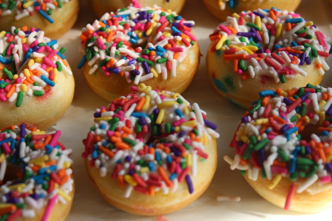 Mini donuts topped with rainbow sprinkles